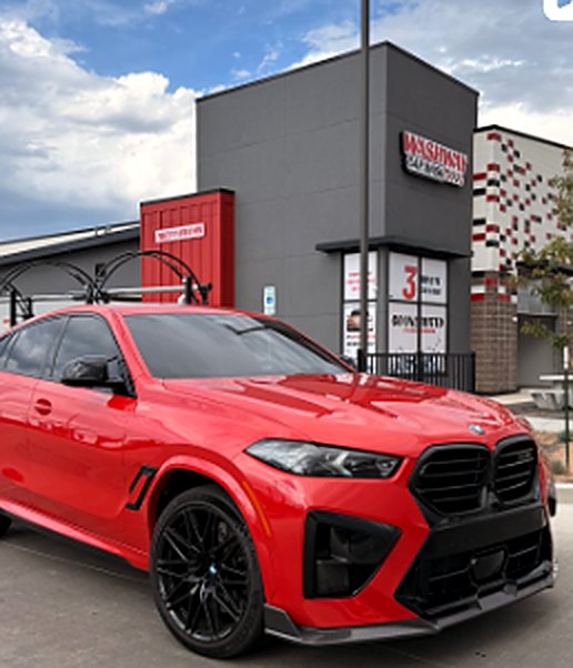A freshly washed red SUV parked outside Washway Car Wash
